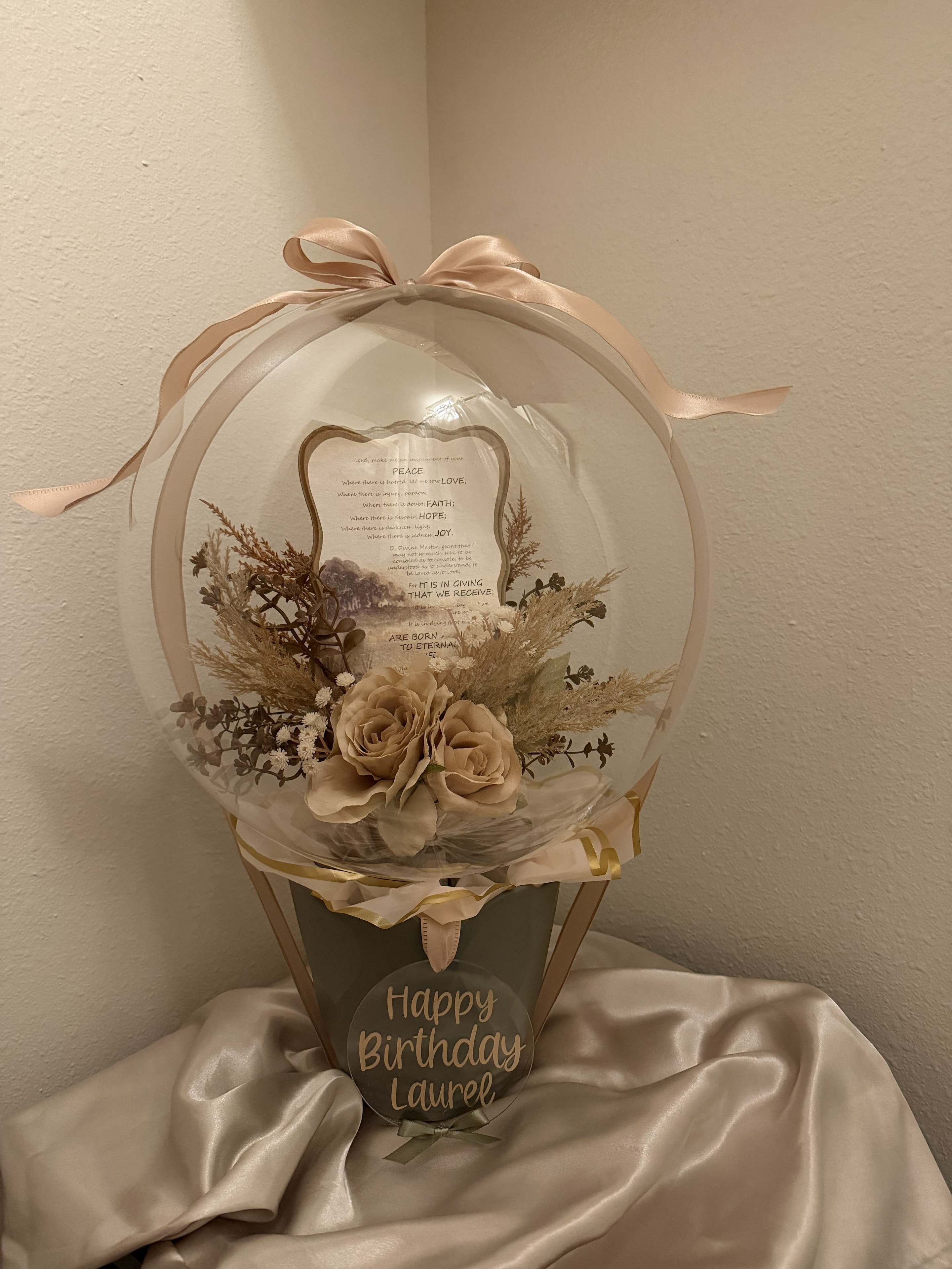 Custom balloon gift arrangement with flowers and ribbon